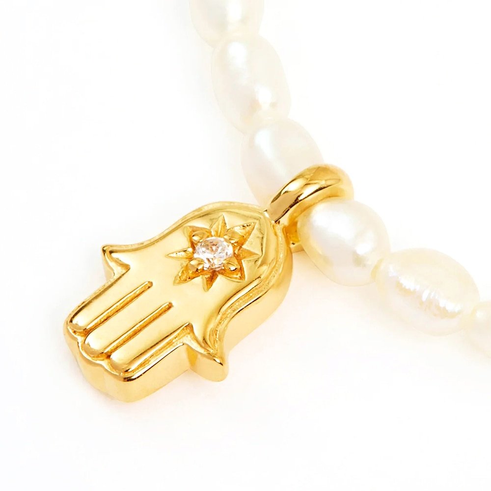 Closeup of the Hamsa Hand Pearl Charm Gold Necklace.