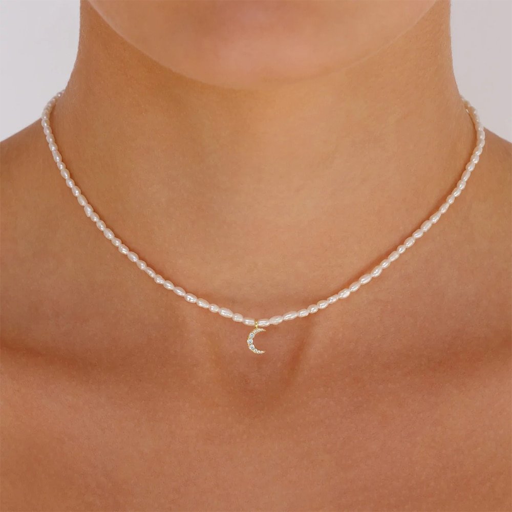 A model wearing the Moon Pearl Charm Gold Necklace.