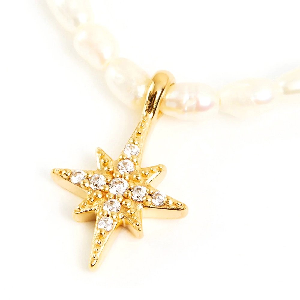 Closeup of the Star Pearl Charm Gold Necklace.