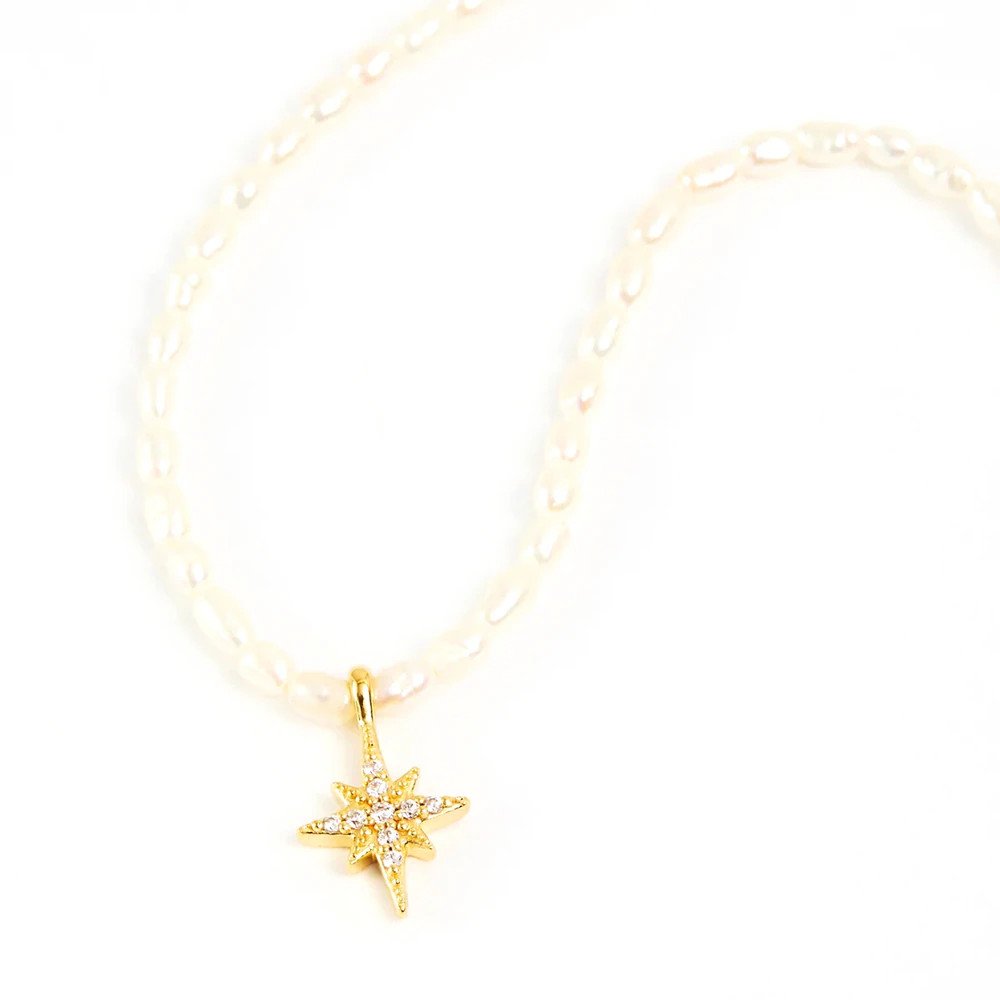 Star pendant on a pearl necklace.