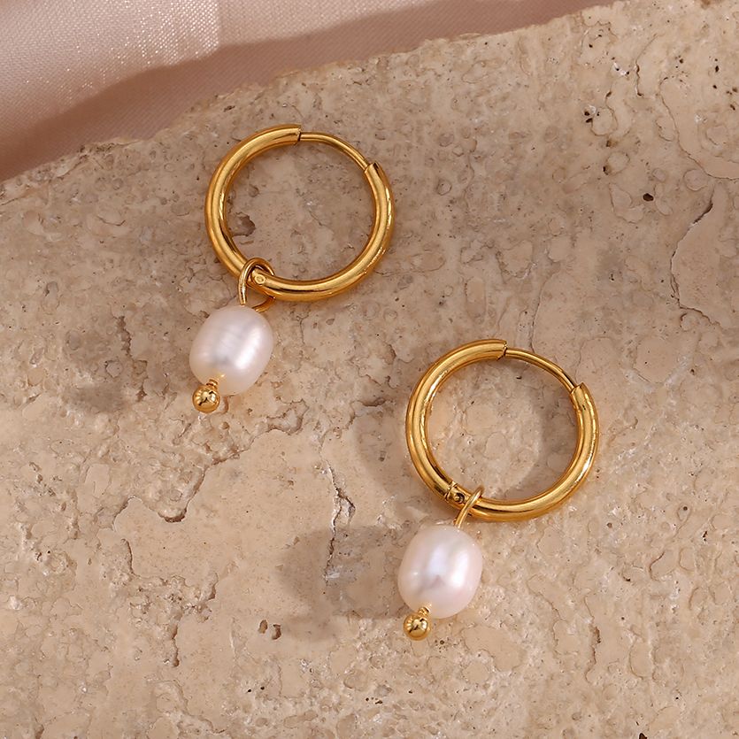 Closeup of the Pearl Dangle Gold Hoops.