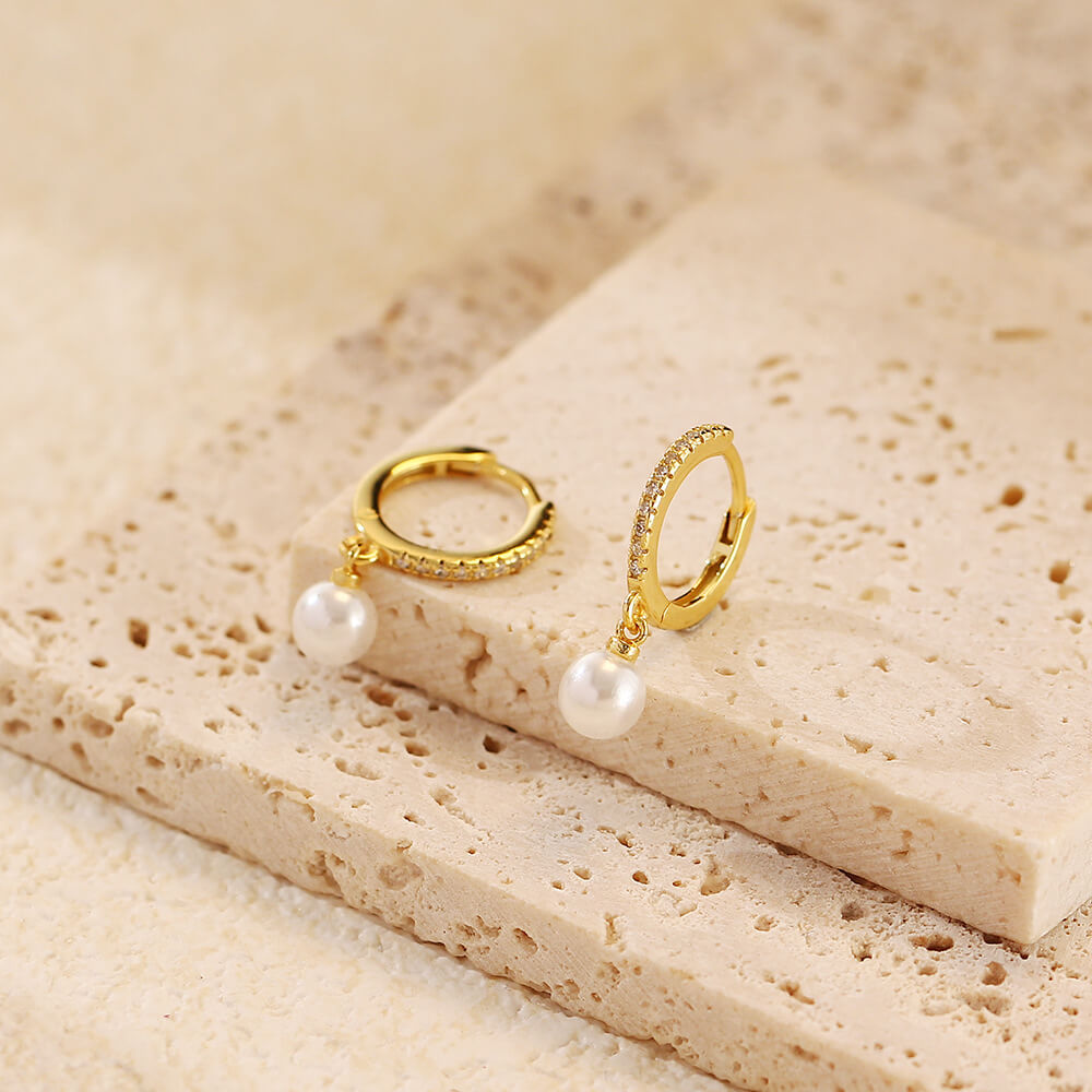 Closeup of the gold Pearl Drop CZ Huggies.