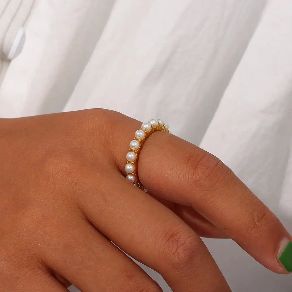 A woman wearing the Pearl Eternity Gold Ring.