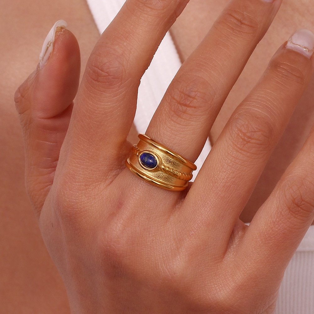 A woman wearing the Western Gold Lapis Ring Band.