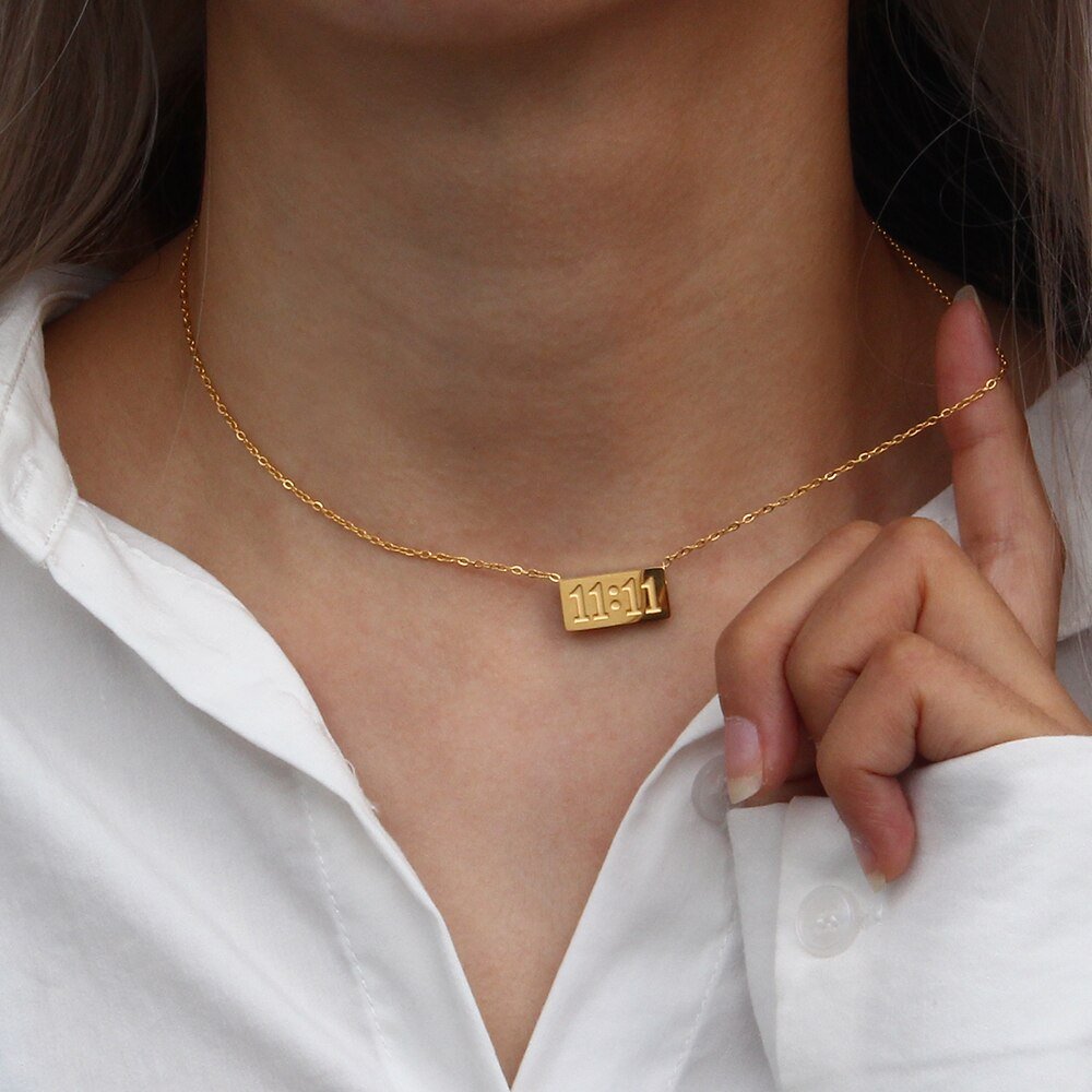 A model wearing the gold 11:11 Bar Necklace.