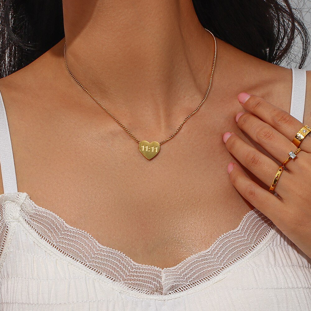 A woman wearing a gold 1111 heart necklace.