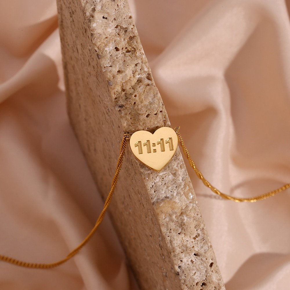 Closeup of the 11:11 Gold Heart Necklace.
