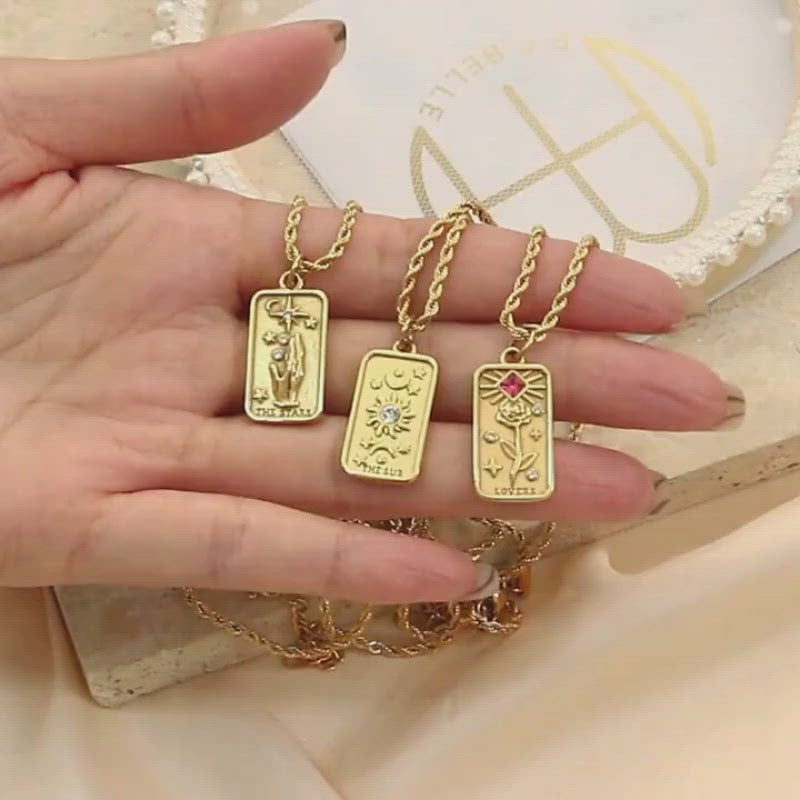 A video showing gold tarot card necklaces.