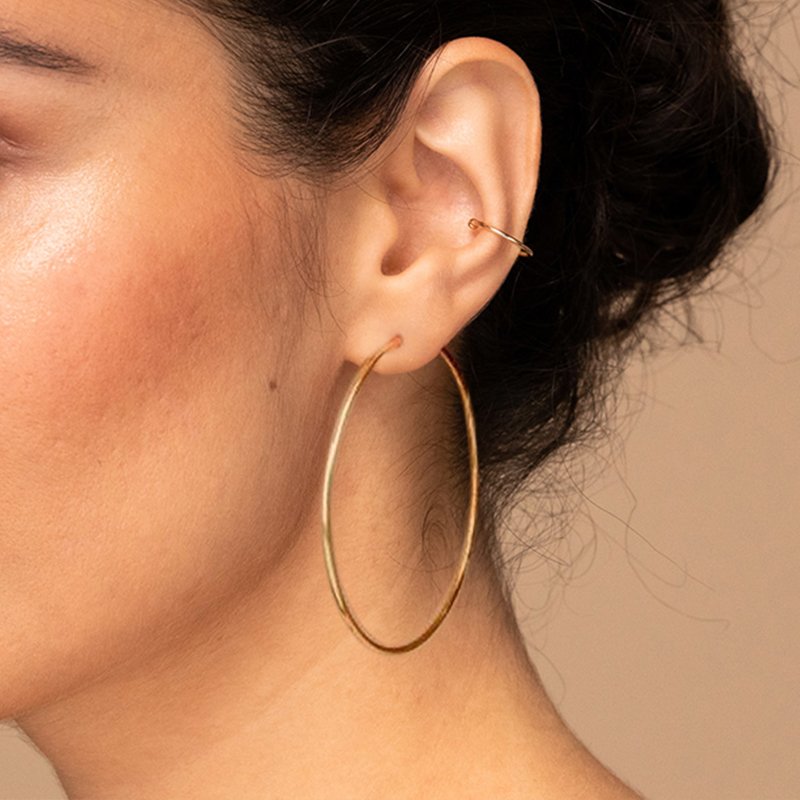 A model wearing large gold hoops.