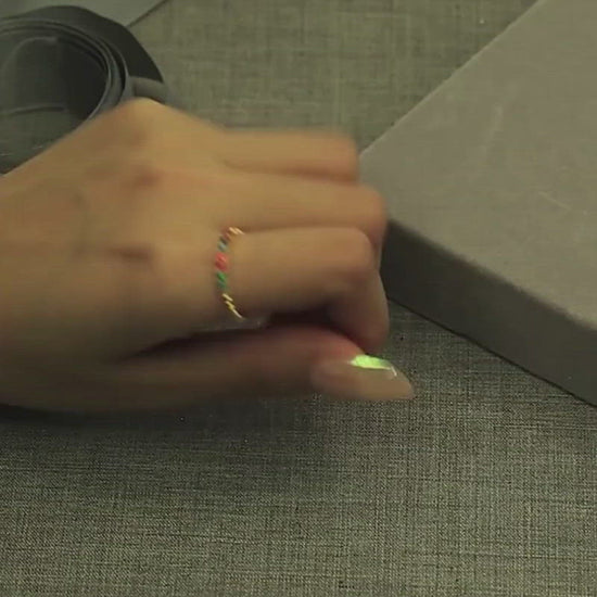 A short video of a model showcasing the Rainbow CZ beaded Ring, putting it on and taking it off.