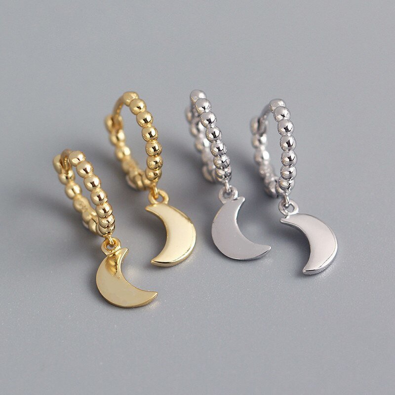 Gold and silver beaded moon huggie earrings.