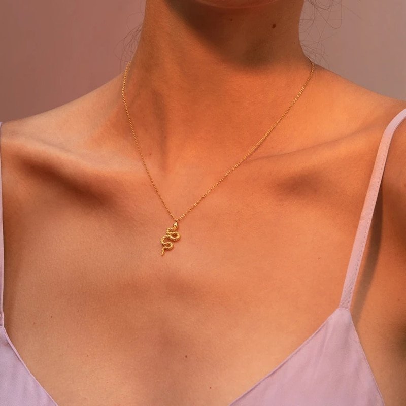 A model wearing the gold Beaded Serpent Necklace.