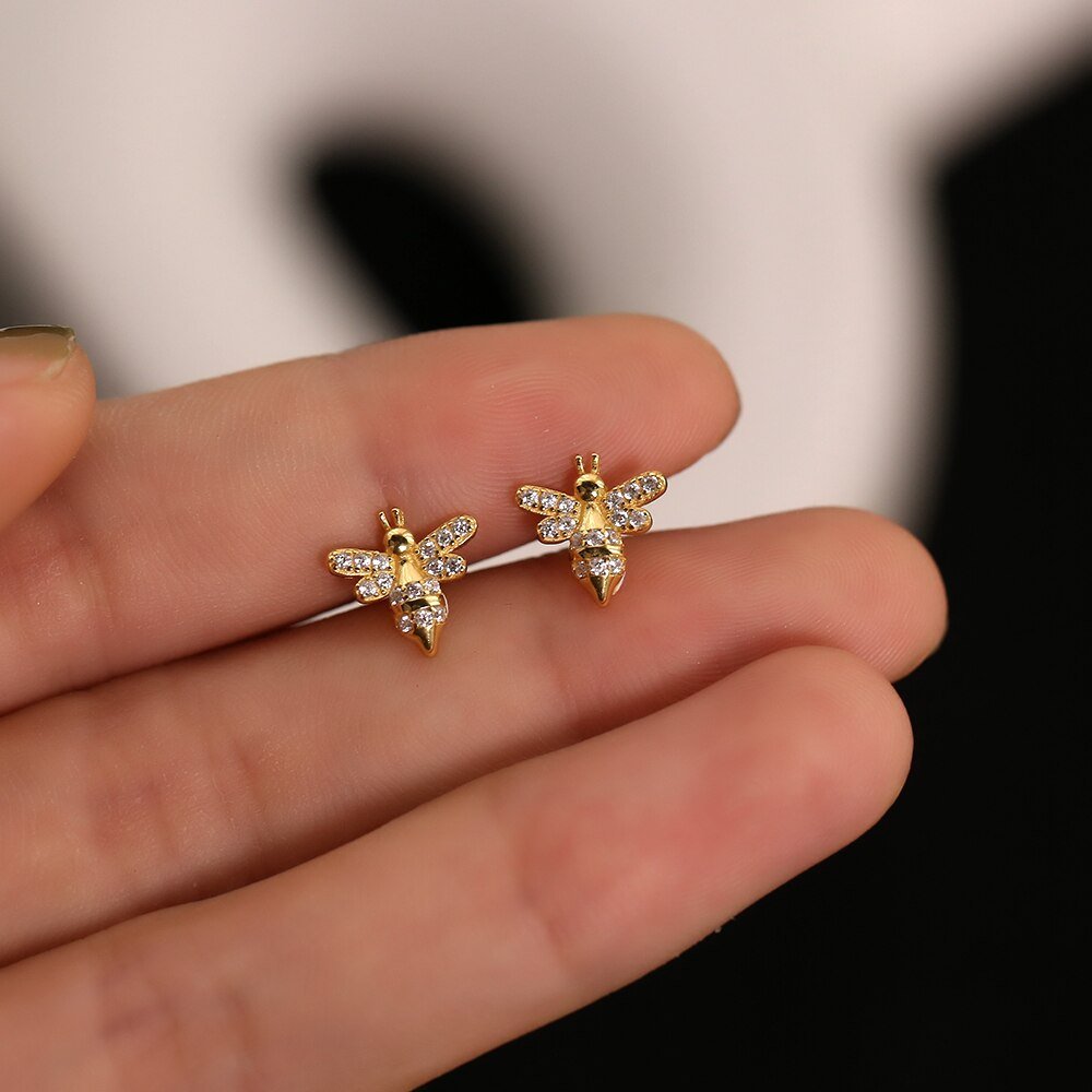 A model holding the Bee CZ Studs.