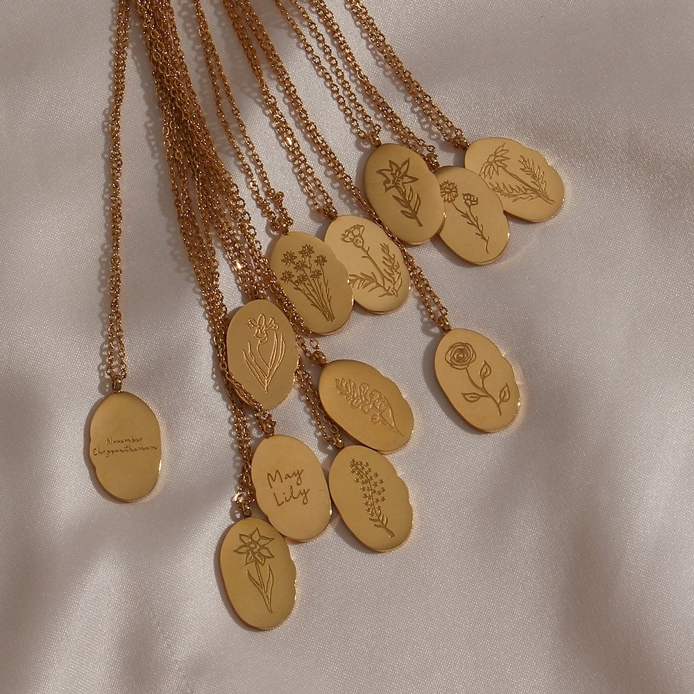 A bunch of gold pendants with flowers engraved.