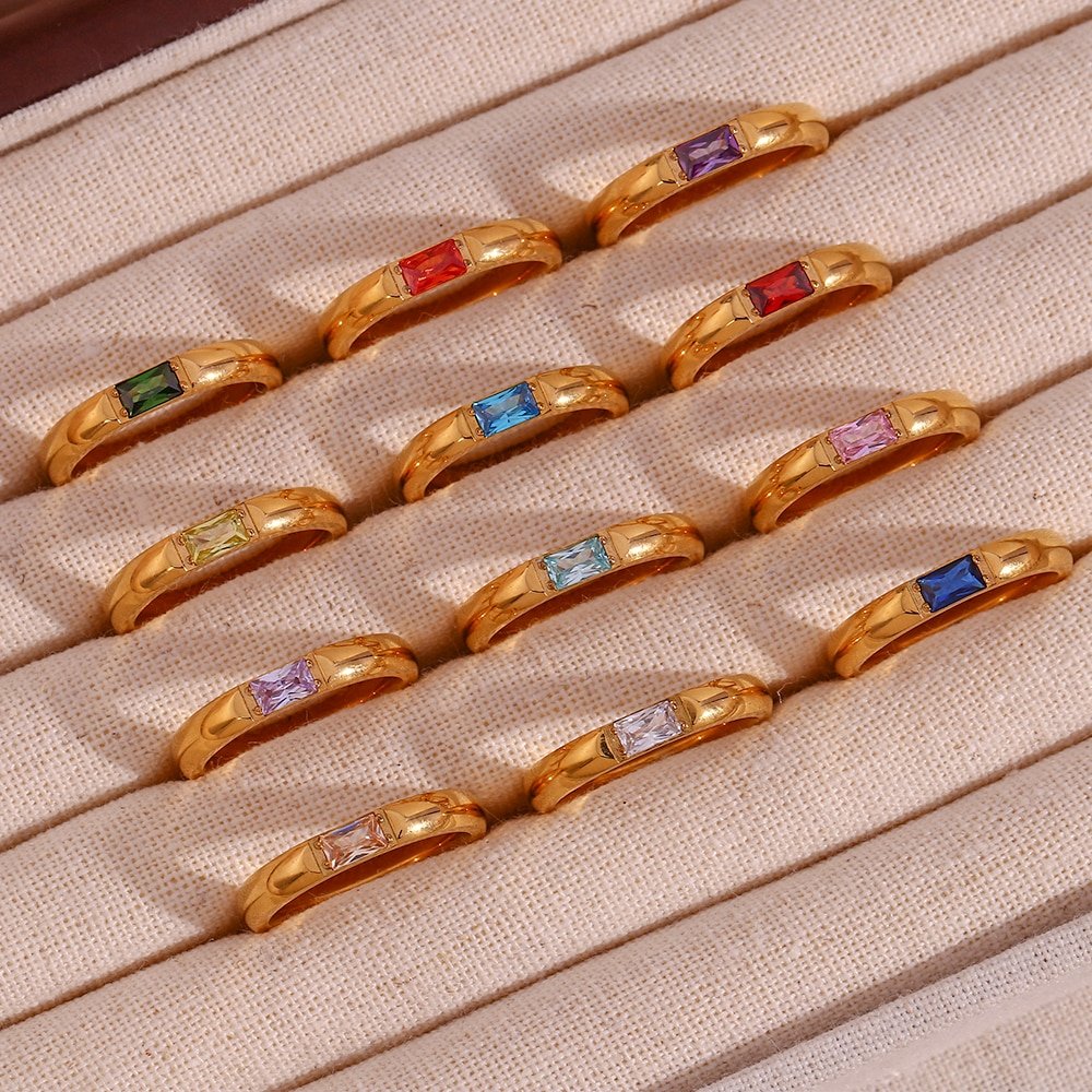 Tweleve gold birthstone rings.