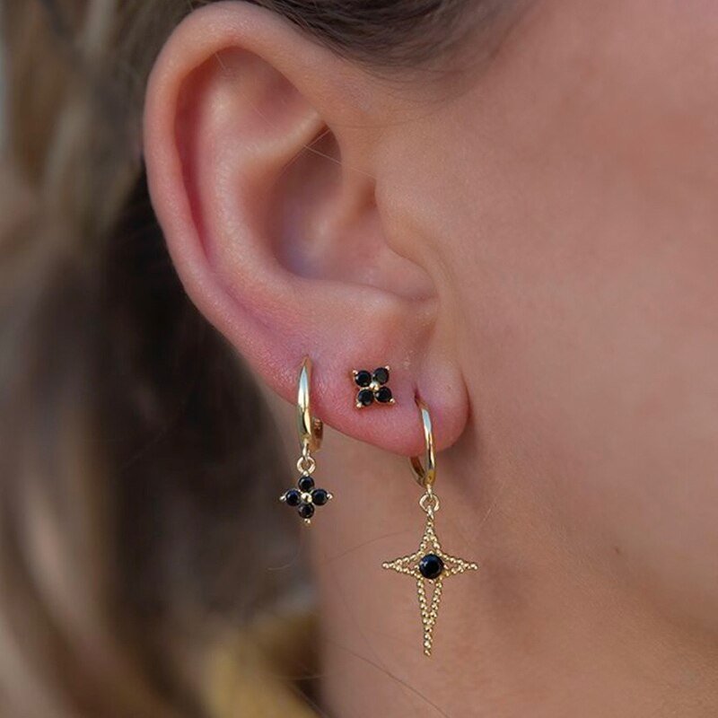 A model wearing multiple Black Zircon Flower earrings.