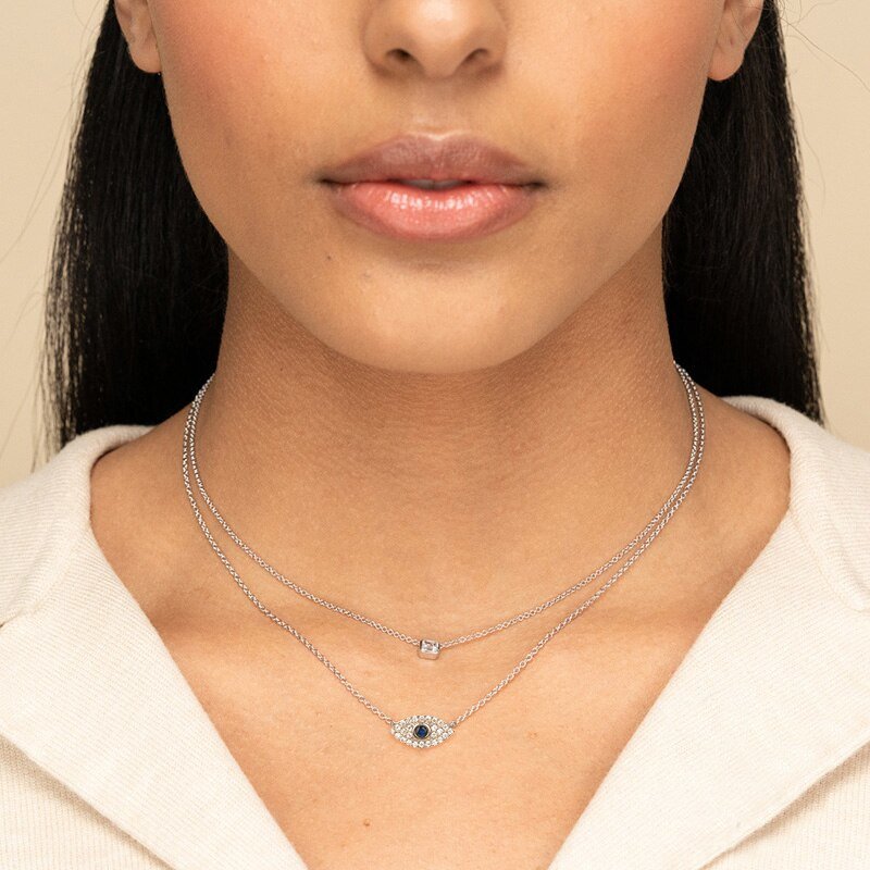 A woman modeling the Blue CZ Evil Eye Necklace in silver.