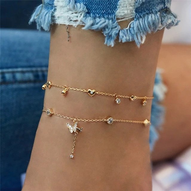 a model wearing the Butterfly Gold Anklet Set.
