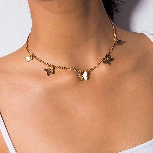 A model wearing the Butterfly Choker Necklace in gold.