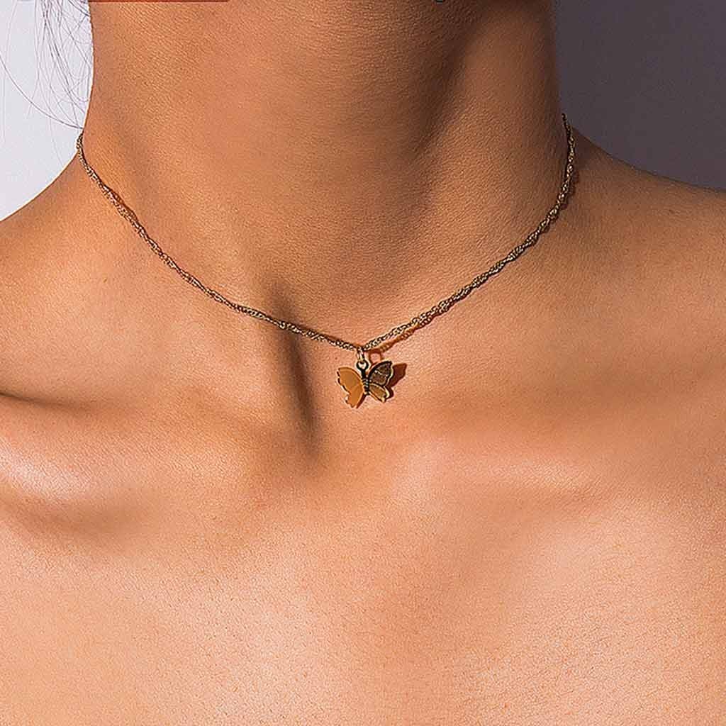 Closeup of a model wearing the Gold Butterfly Necklace.