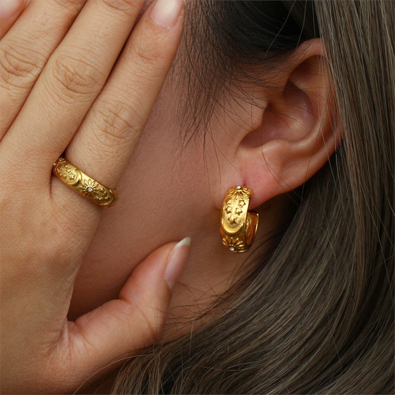 A model wearing the Celeste Gold Ring and Hoops.