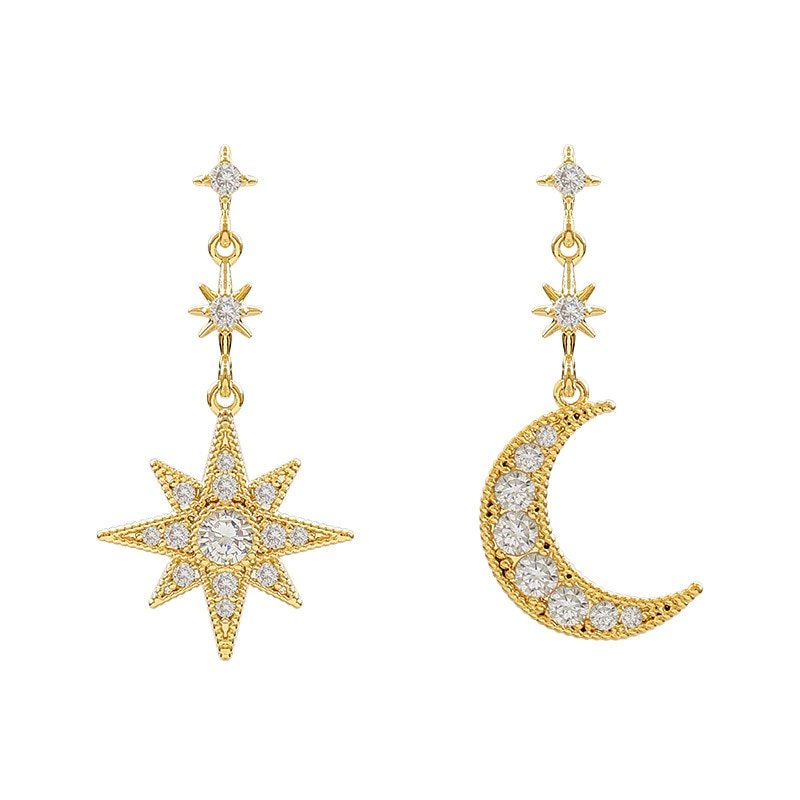Gold star moon mismatched earrings.