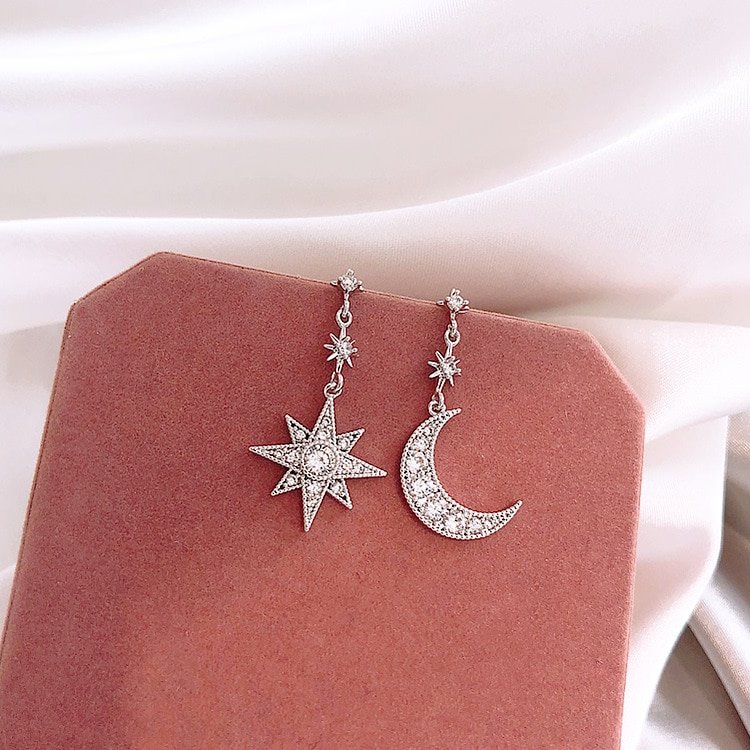 Silver sparkly star and moon earrings.