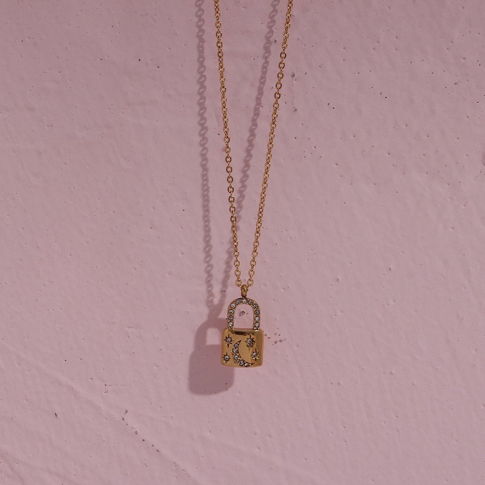 Crescent moon padlock necklace in gold.