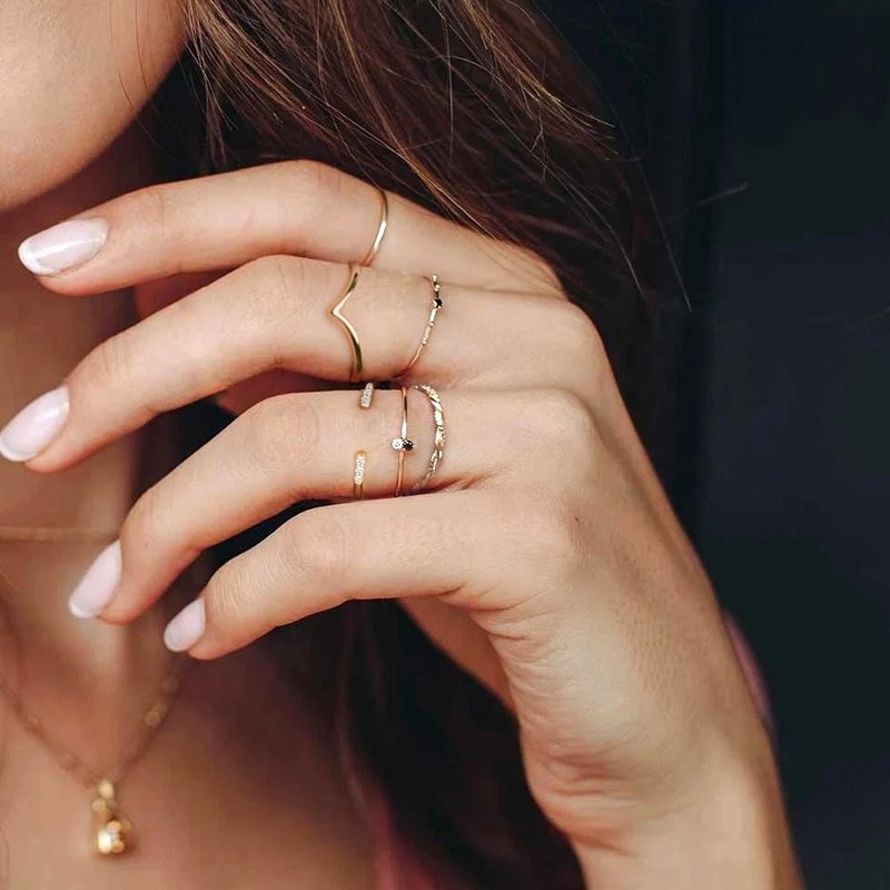 A model wearing multiple gold stacking rings.