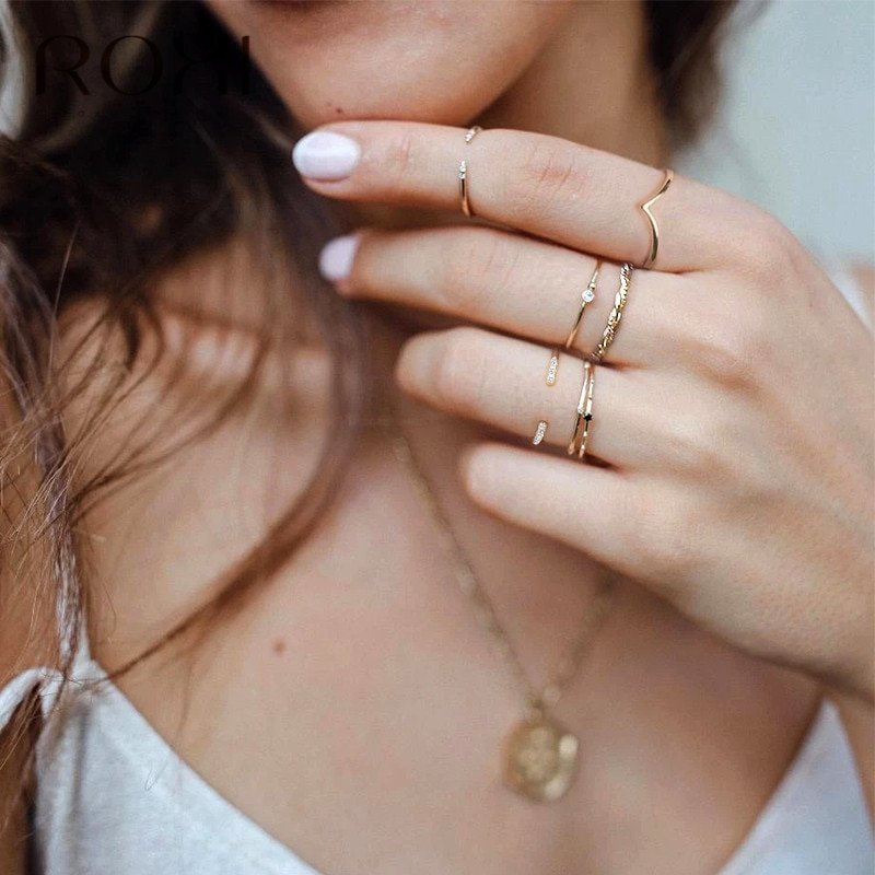 A model wearing dainty gold stacking rings.