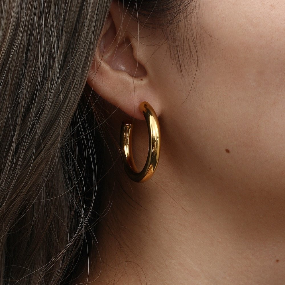 A model wearing Chunky Gold Hoops.