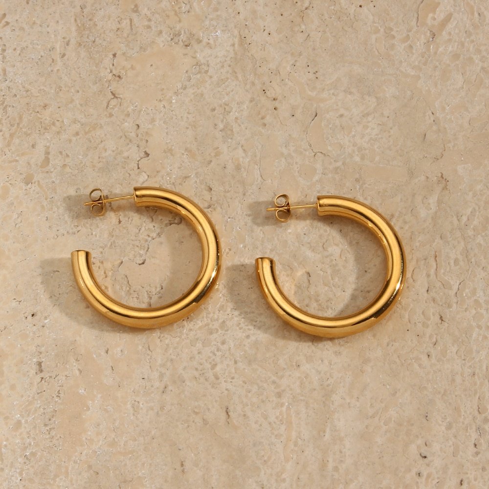 Chunky hollow gold hoop earrings.