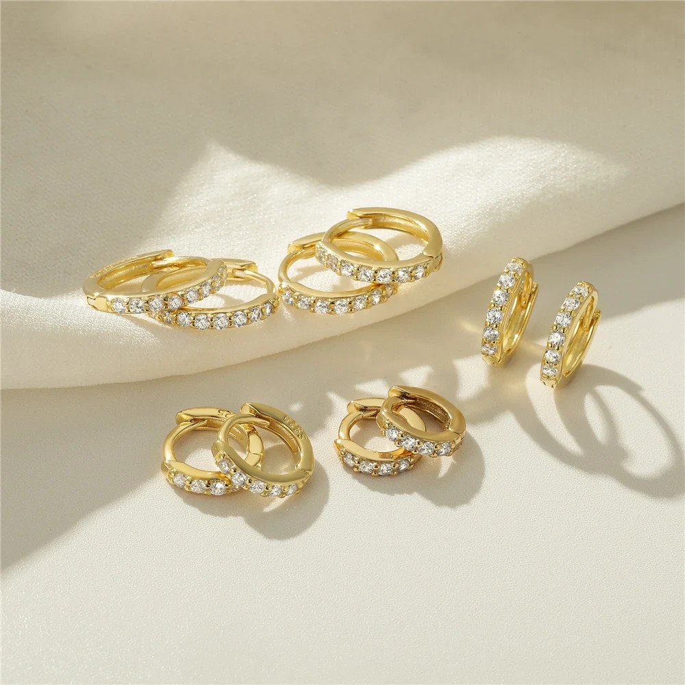Multiple sizes of the Classic Pavé Huggies in gold.