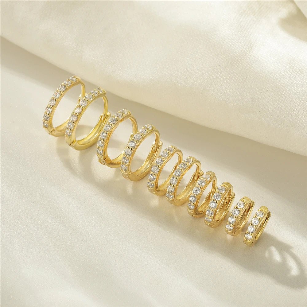 Closeup of the Classic Pavé Huggies in gold.