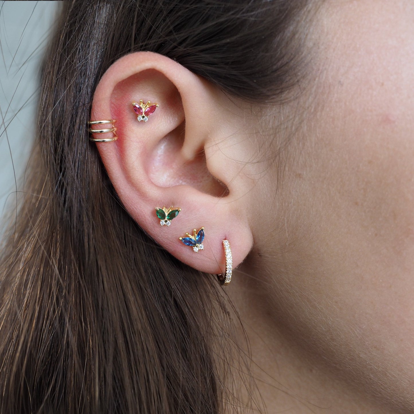 A model wearing pink, green and blue Colorful CZ Butterfly Studs.