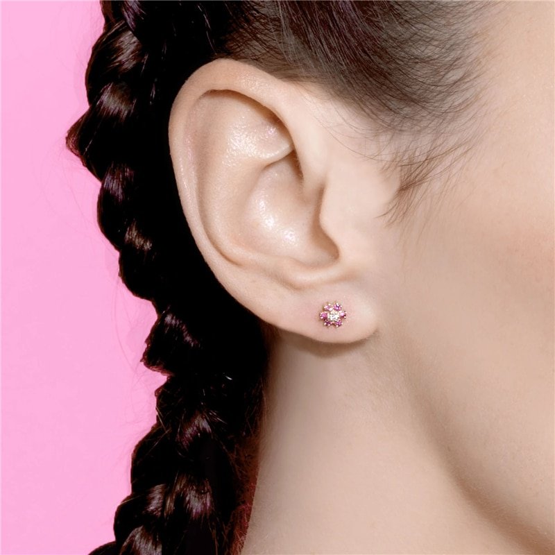 A model wearing pink CZ Flower Studs.