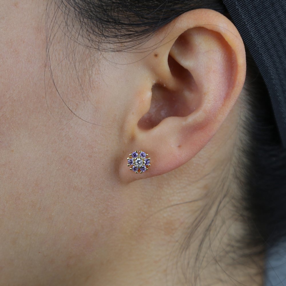 A model wearing purple CZ Flower Studs.