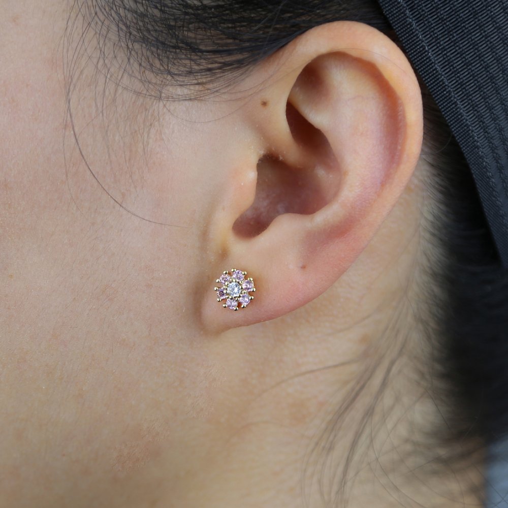 A model wearing light pink CZ Flower Studs.