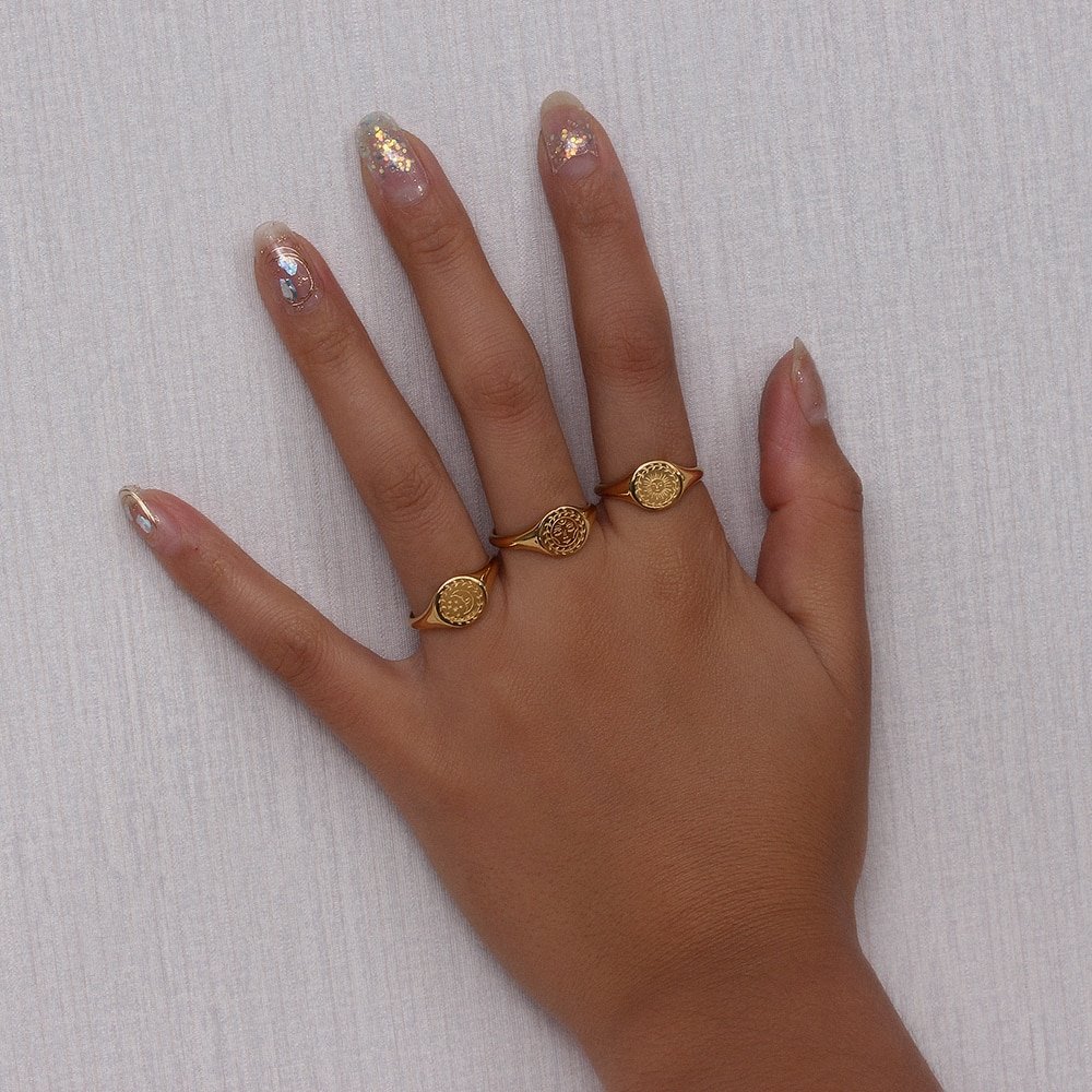 A woman wearing multiple gold rings.