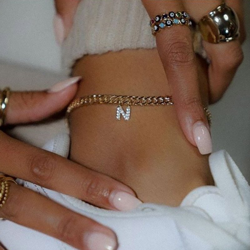 A model wearing a Gold N Initial Anklet.