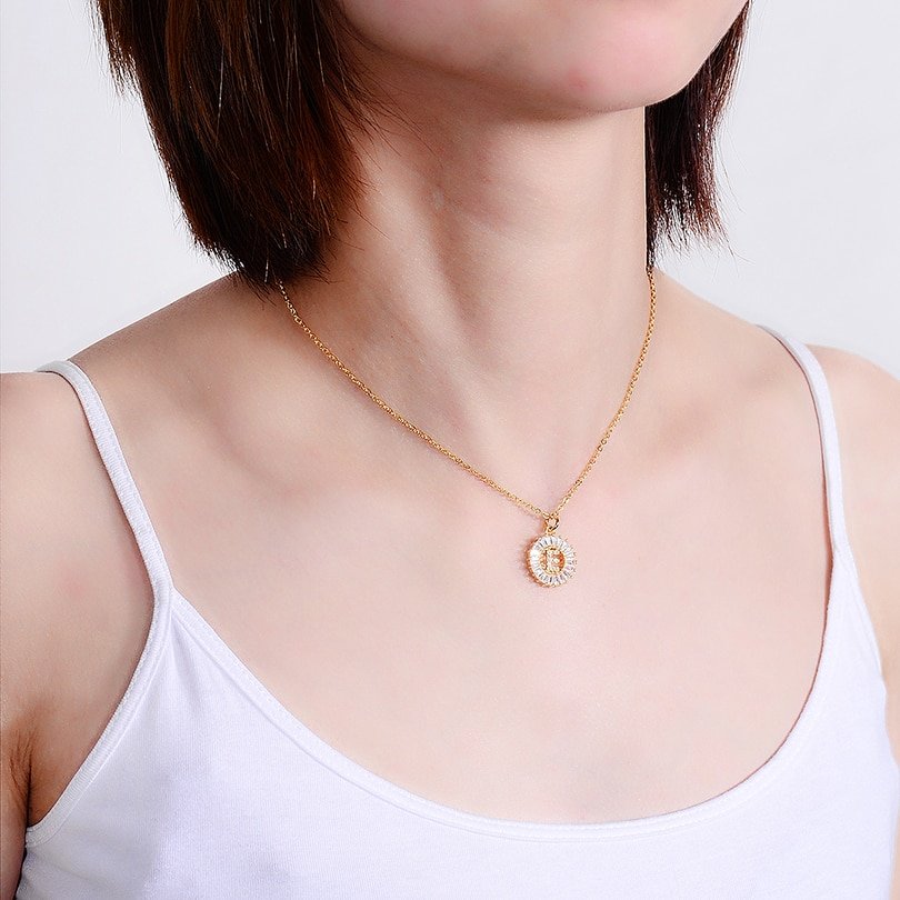A model wearing the Gold Crystal Monogram Necklace.