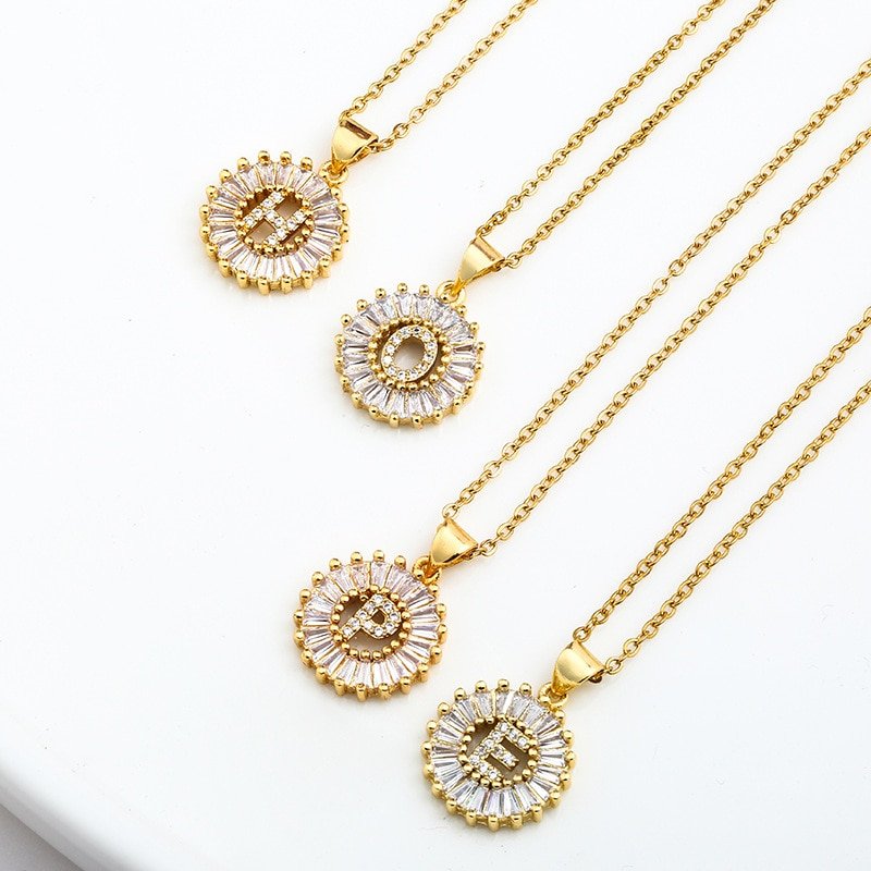 Four Gold Crystal Monogram Necklaces spelling out the word Hope.