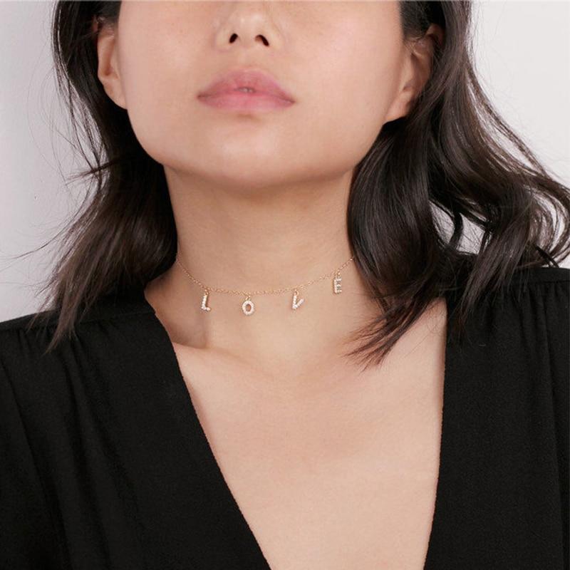 A model wearing a "Love" word necklace.