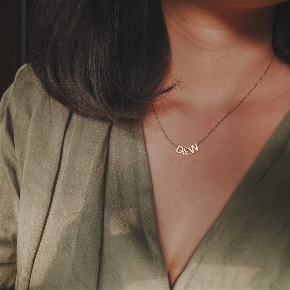 A model wearing a gold custom letter necklace D&W.