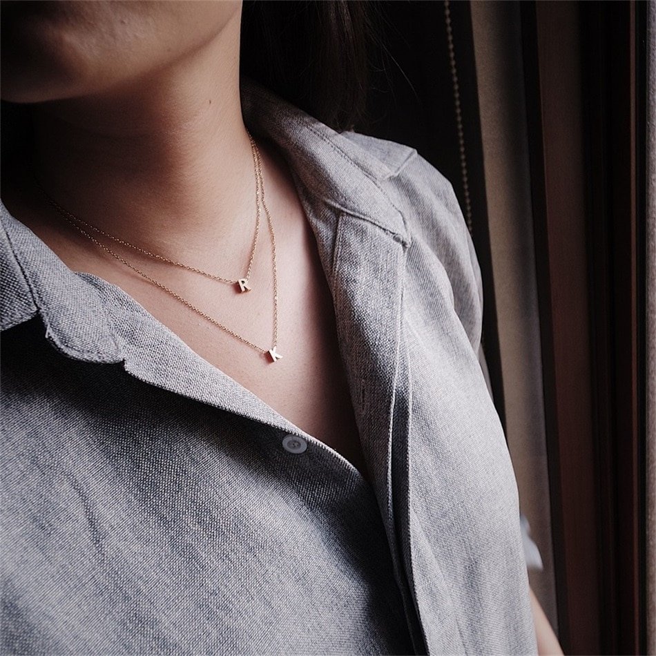 A model wearing an initial necklace.