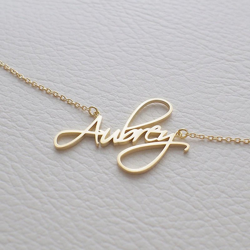 Closeup of the Custom Name Necklace in gold.