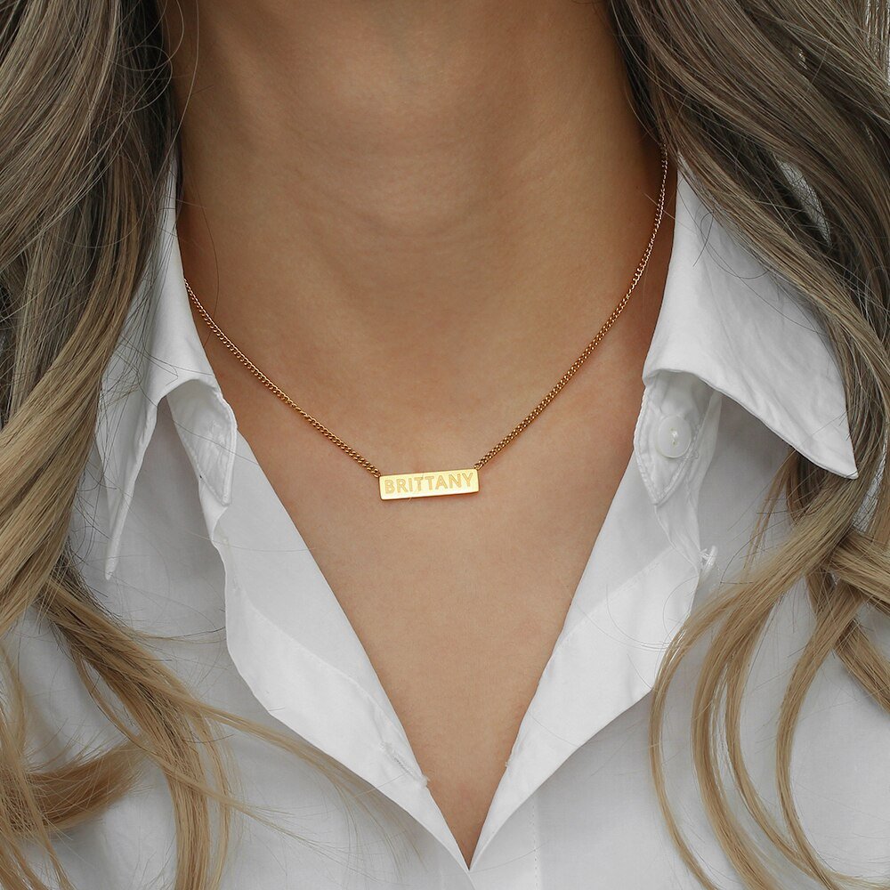 A model wearing the Custom Name Plate Necklace.