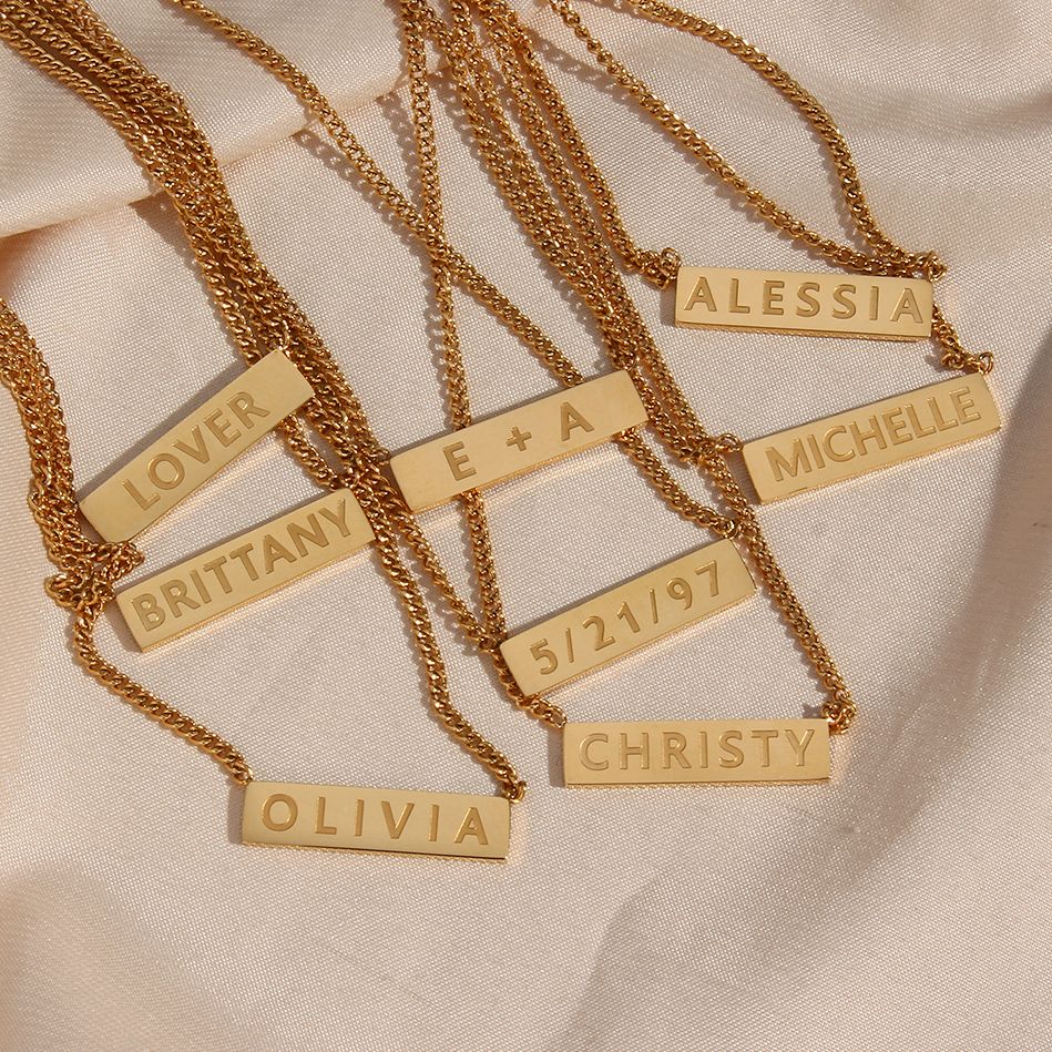 Customizable gold bar necklaces.