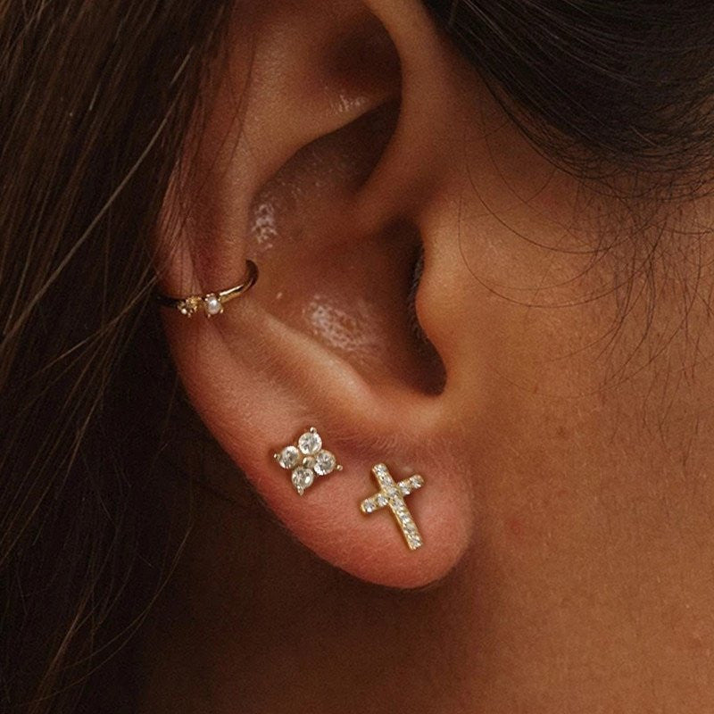 A model wearing gold CZ Pave Cross Studs.