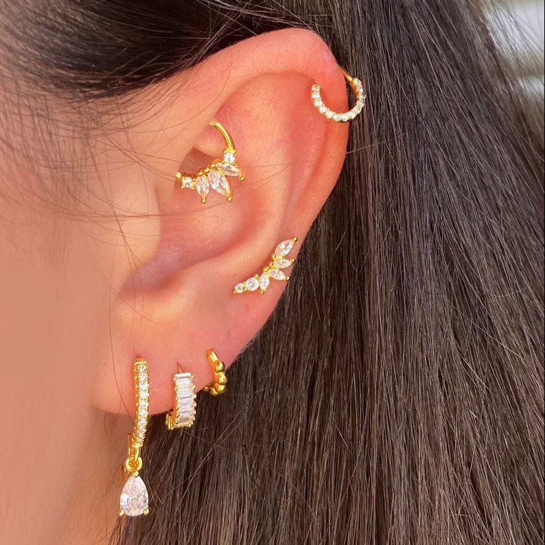 A model wearing the gold CZ Pave Rook Piercing.
